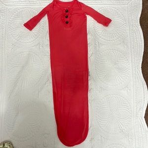 Newborn GiGi and Max tie gown. Color is coral.